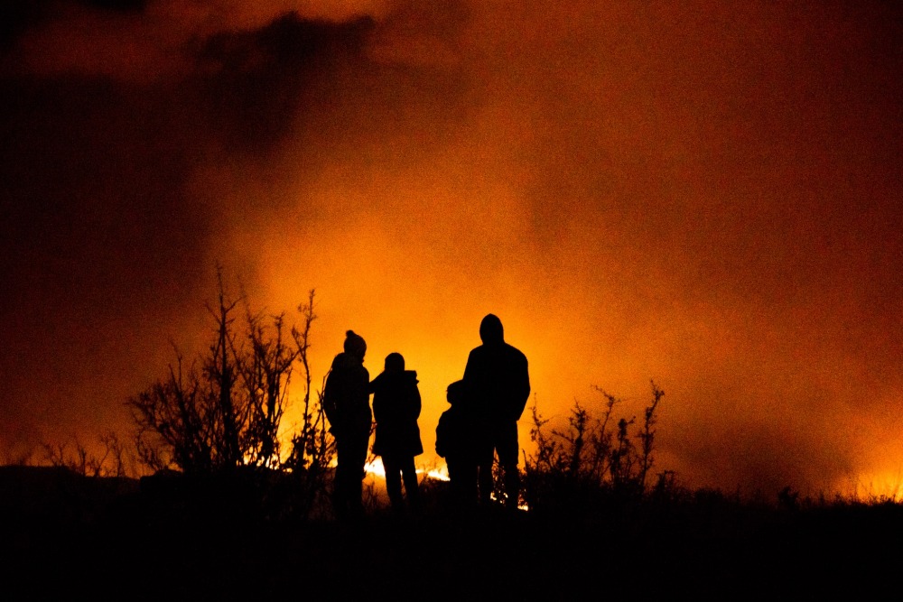 Family watching a wildfire in the distance in the summer of 2020. Caleb Cook, unsplash
